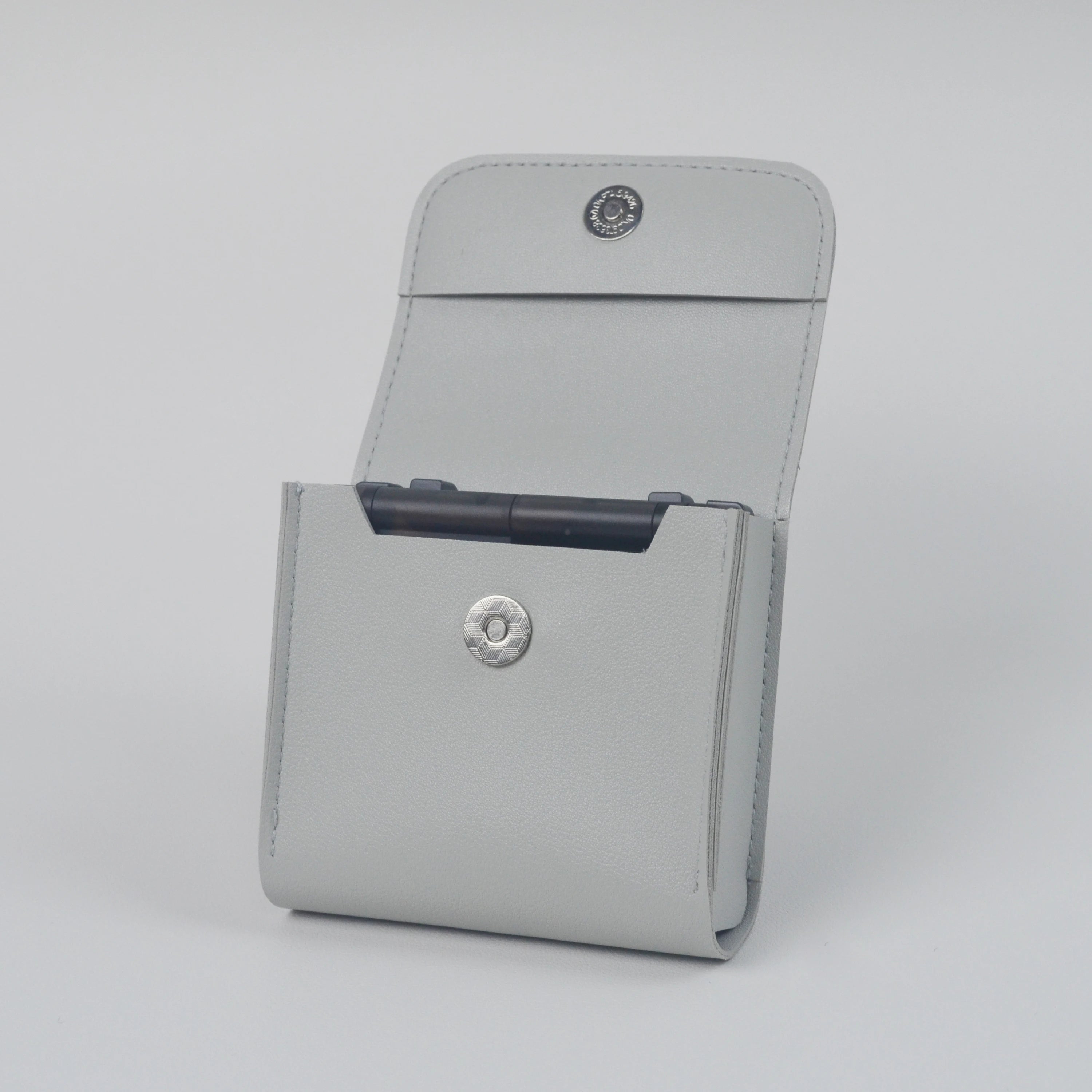 Gray case with button details on a light gray background