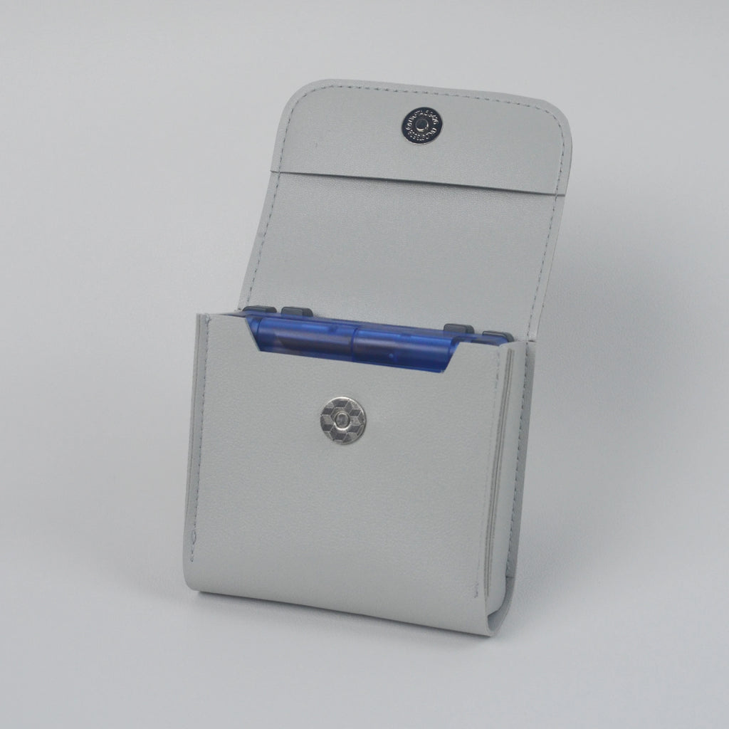 Gray cardholder with blue cards on a light gray background